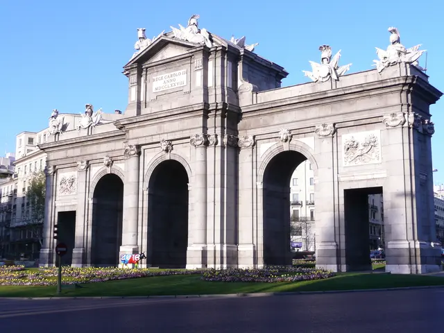 In this image in the center there are some buildings and some sculptures. At the bottom there is...