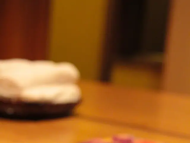 This is a table. On the table there are chopsticks and a plate.