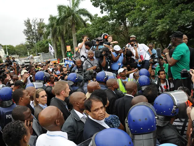 In this picture I can see few people standing and few of them wore helmets on their heads and a man...