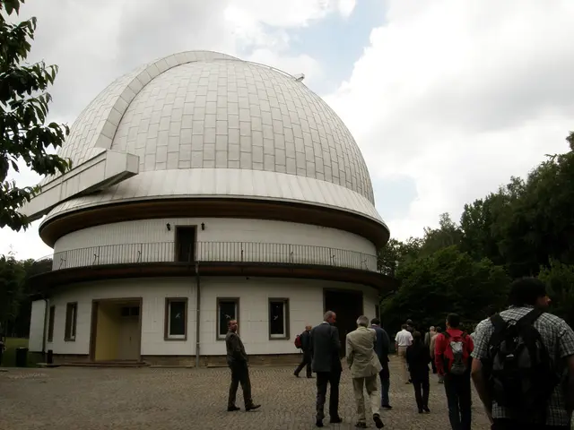 In this image we can see people walking on the floor and some of them are wearing backpacks. In the...