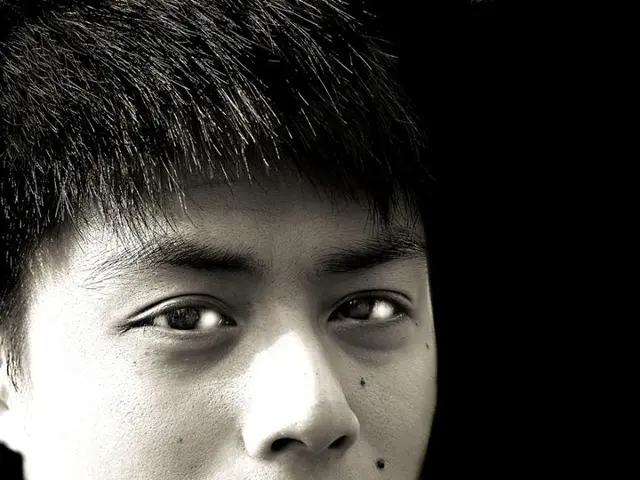 In the picture a person posing for the photo,the background of the person is black and it is a...